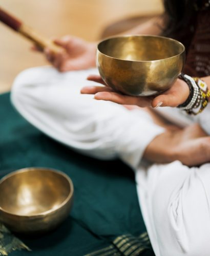 person in white dress shirt holding brown wooden chopsticks